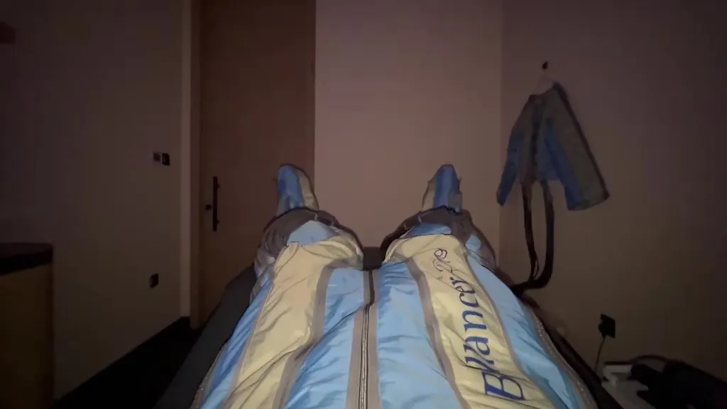 Bobby lying back with inflatable compression boots on both legs.