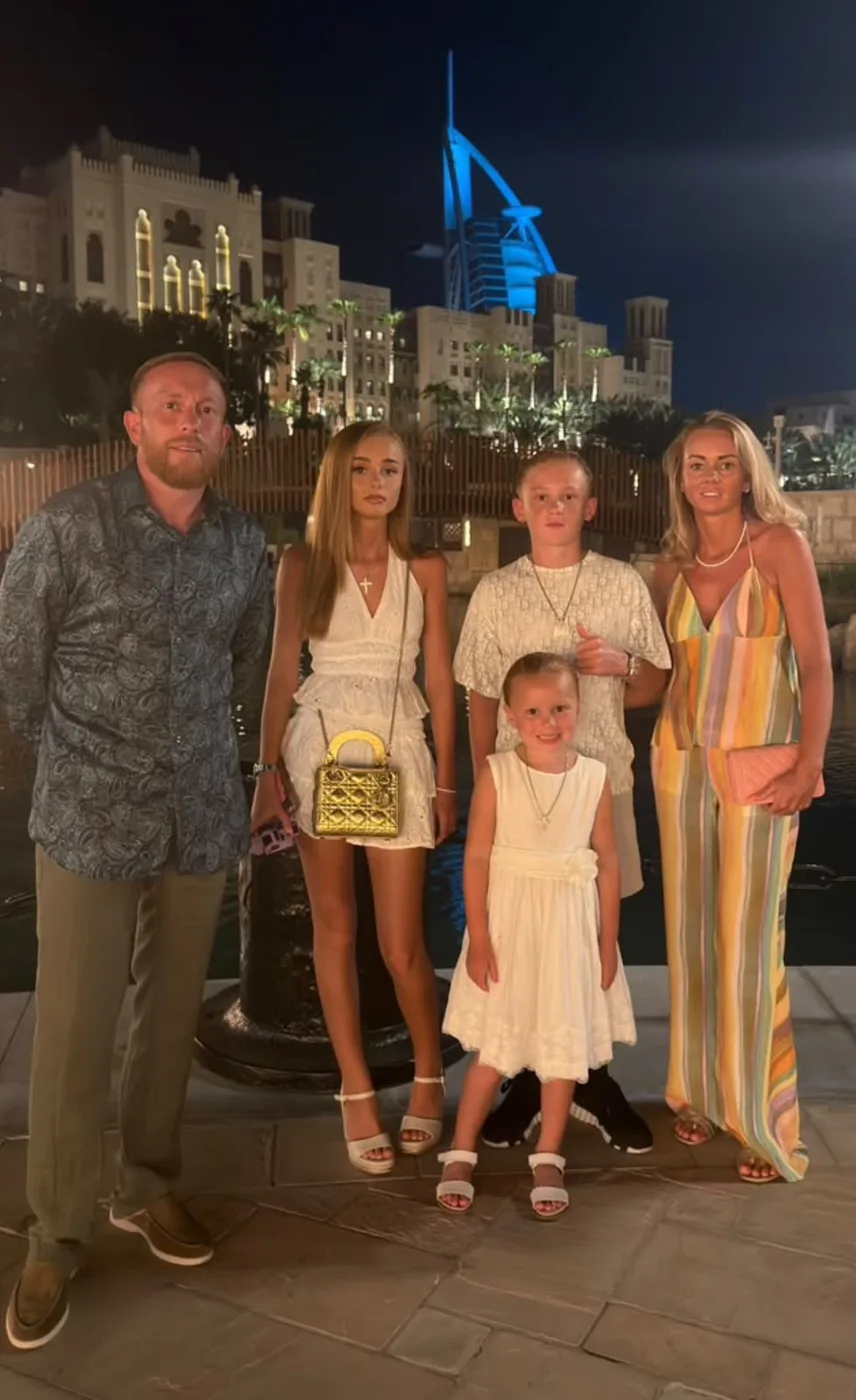 Bobby with his wife and three children in Dubai at night.